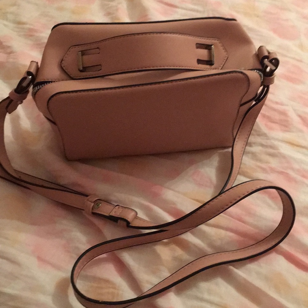Purse pink/tan color adjustable strap.